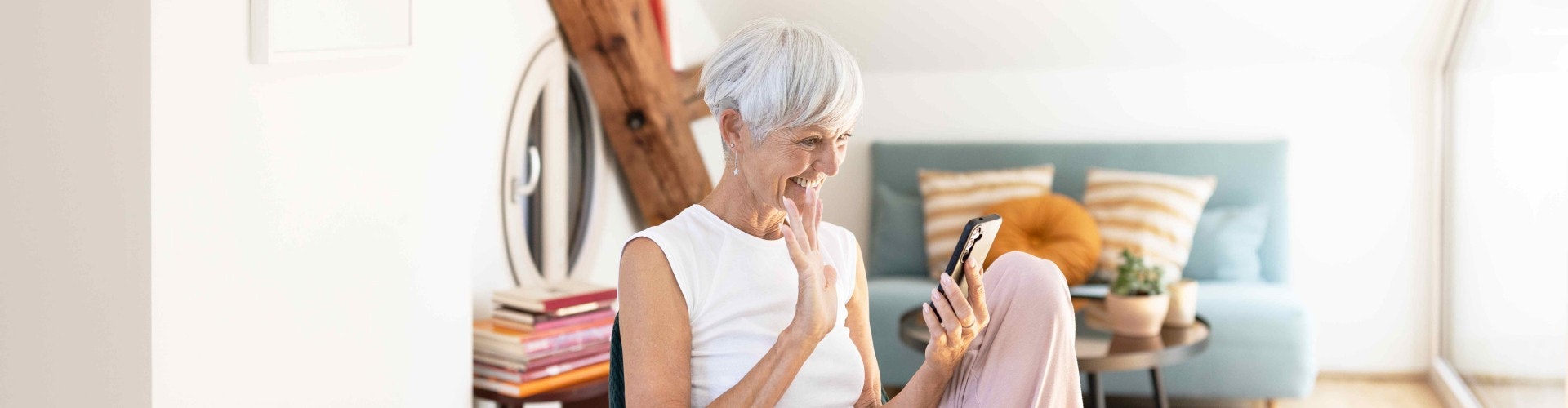 Grandmother videochatting with her grandchildren while streaming the sound from the call directly to her SONNET 3s