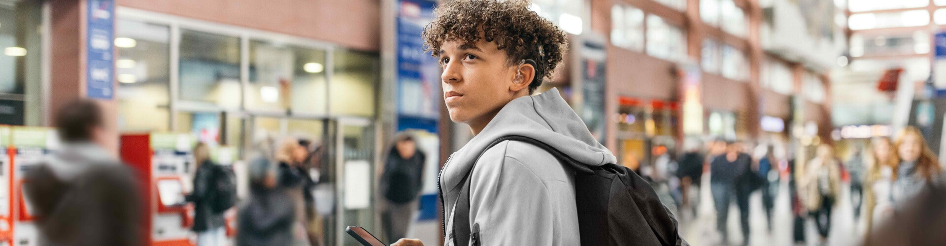 teenager at the train station streaming music directly from his smartphone to his SONNET 3