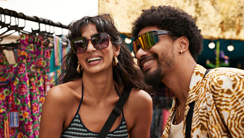 A couple trying on sunglasses.